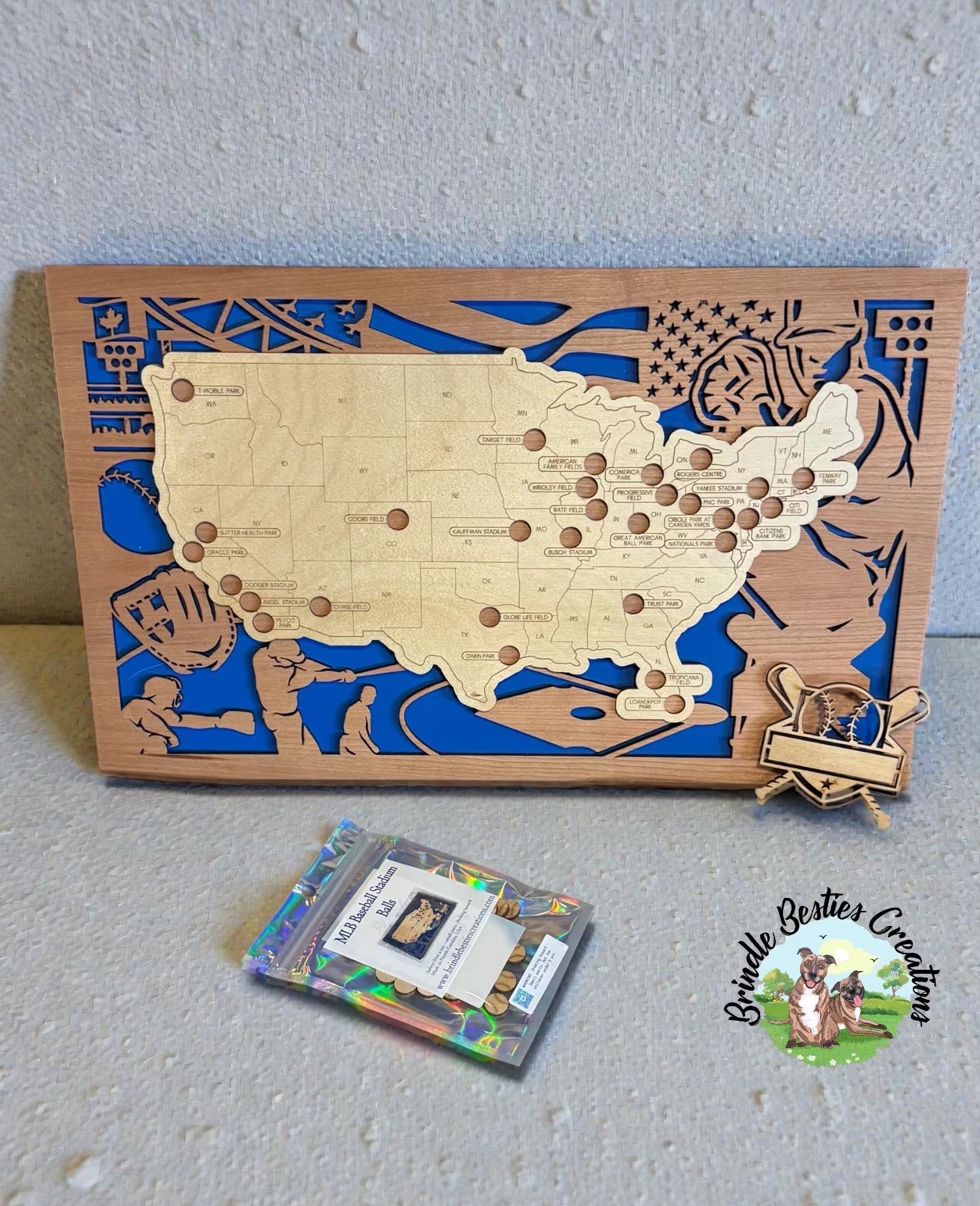 Laser cut MLB ballpark map with wood layers, blue backing, and marker pieces.