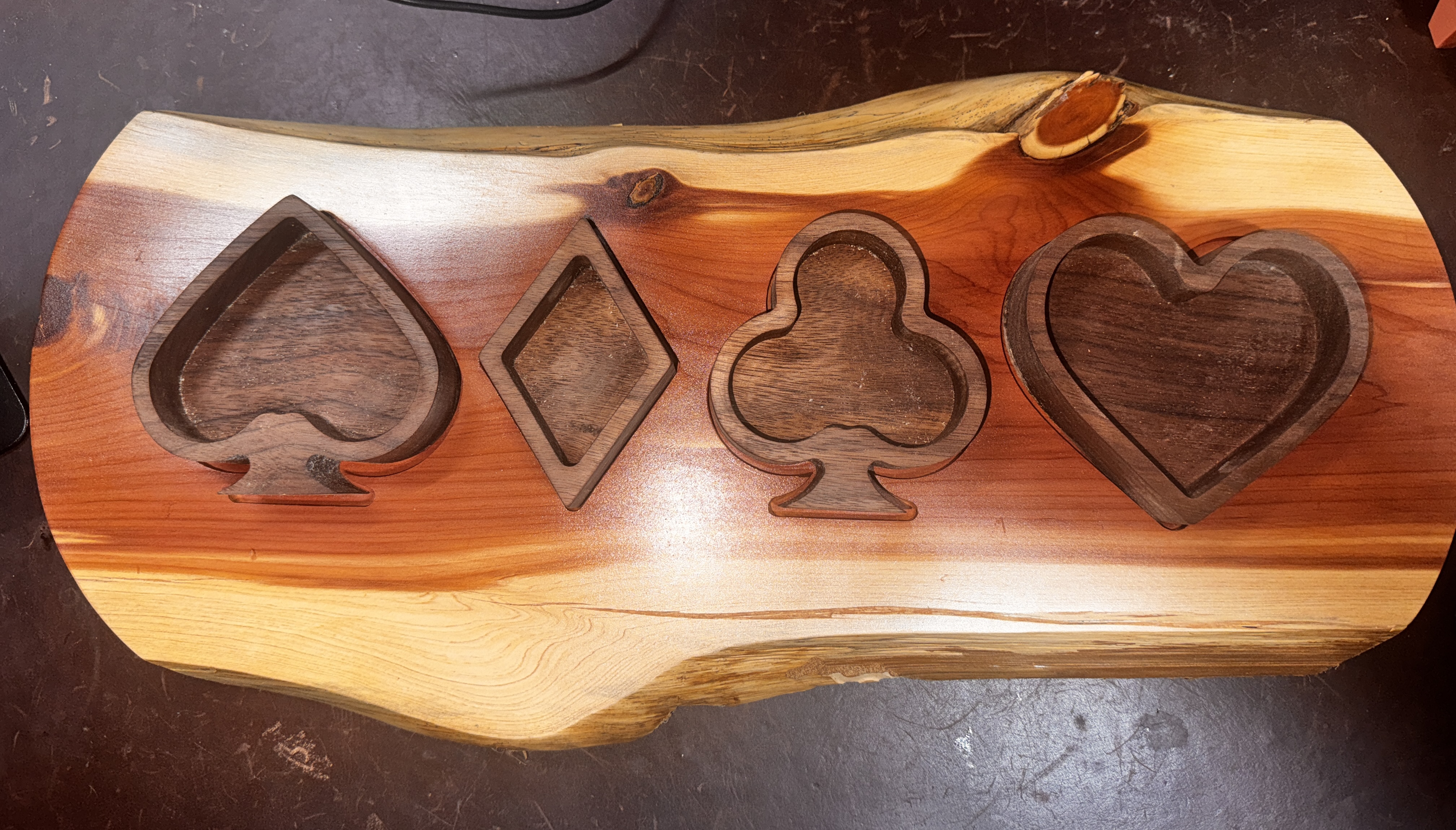 Live-edge cedar tray with CNC-carved playing card suit bowls.